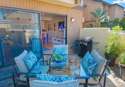 a patio with chairs and a glass table at Love Bug by Funtierland Vacation Rentals in Anaheim