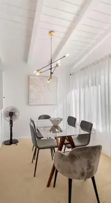 a dining room with a table and chairs at Steps to Sand Cozy 3BR Partial Ocean Views in Manhattan Beach