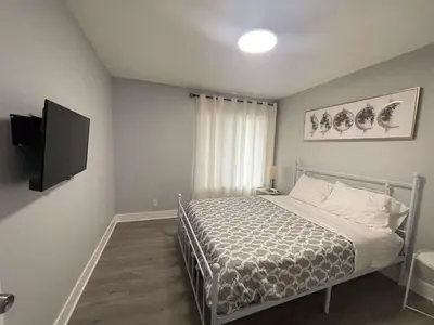 a bedroom with a bed and a flat screen tv at 5 Bedroom House with fabulous mountain views in Hacienda Heights