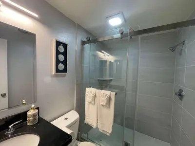 a bathroom with a shower and a toilet and a sink at 5 Bedroom House with fabulous mountain views in Hacienda Heights