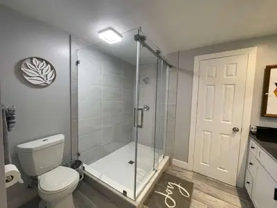 a bathroom with a shower stall and a toilet at 5 Bedroom House with fabulous mountain views in Hacienda Heights