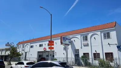 a white building with a car parked in front of it at Dream Inn in Inglewood