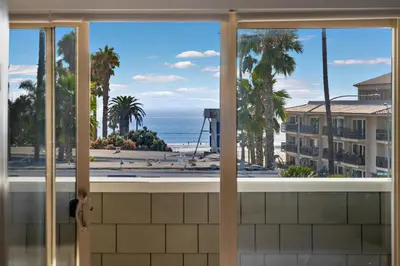 a view of the beach from a window at Ocean Views - Rooftop Pool 2BR Santa Monica in Los Angeles