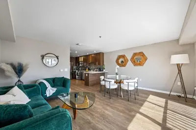 a living room with a couch and a table at Ocean Views - Rooftop Pool 2BR Santa Monica in Los Angeles