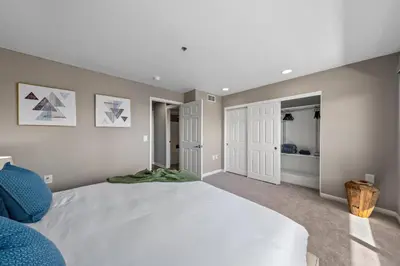 a bedroom with a large white bed in a room at Ocean Views - Rooftop Pool 2BR Santa Monica in Los Angeles
