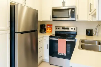 a kitchen with a stainless steel refrigerator and a microwave at Redondo Huge 1Bedroom,3 Queens, close to Beach Sleeps 7 in Redondo Beach