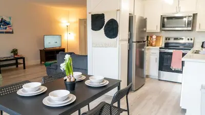 a kitchen and dining room with a table and a refrigerator at Redondo Huge 1Bedroom,3 Queens, close to Beach Sleeps 7 in Redondo Beach