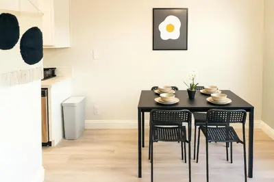 a dining room with a black table and chairs at Redondo Huge 1Bedroom,3 Queens, close to Beach Sleeps 7 in Redondo Beach