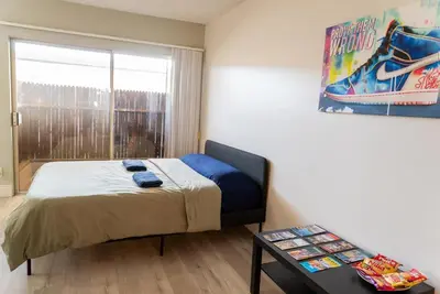 a bedroom with a bed and a window and a table at Redondo Huge 1Bedroom,3 Queens, close to Beach Sleeps 7 in Redondo Beach