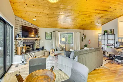 a living room with a couch and a fireplace at 2 Mi to Lake Arrowhead Treetop Retreat with Deck in Lake Arrowhead