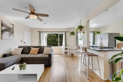 a living room with a couch and a kitchen at Beautifully Remodeled 2bed1bath Apartment Top Location 15 min to Beach in Los Angeles