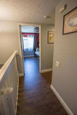 a hallway of a home with a staircase and a room with a hallway at Radiator Springs by Funtierland Vacation Rentals in Anaheim