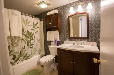 a bathroom with a sink and a toilet and a mirror at Radiator Springs by Funtierland Vacation Rentals in Anaheim