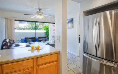 a kitchen with a stainless steel refrigerator at Tron by Funtierland Vacation Rentals in Anaheim