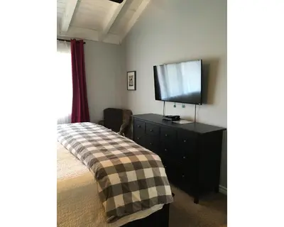 a bedroom with a bed and a flat screen tv at Arendelle by Funtierland Vacation Rentals in Anaheim