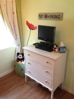 a dresser with a television on top of it at Pixie Hollow by Funtierland Vacation Rentals in Anaheim