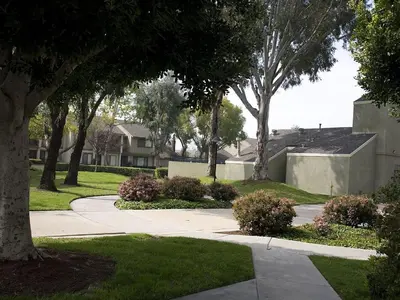 a walkway in a yard with trees and bushes at Pixie Hollow by Funtierland Vacation Rentals in Anaheim