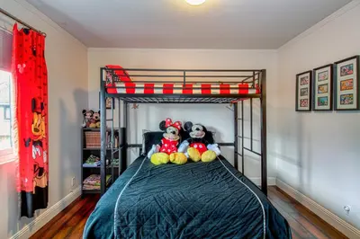 two stuffed animals sitting on a bed in a bedroom at Maleficents Retreat by Funtierland Vacation Rentals in Anaheim