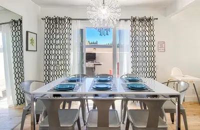 a dining room with a white table and chairs at New Suite Escapes 5 by Funtierland Vacation Rentals in Anaheim