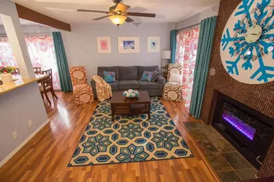 a living room with a couch and a fireplace at Bedknobs and Broomsticks by Funtierland Vacation Rentals in Anaheim