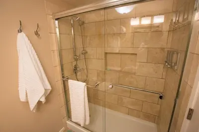 a bathroom with a shower with a glass door at Under the Sea by Funtierland Vacation Rentals in Anaheim