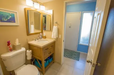 a bathroom with a toilet and a sink and a mirror at Under the Sea by Funtierland Vacation Rentals in Anaheim