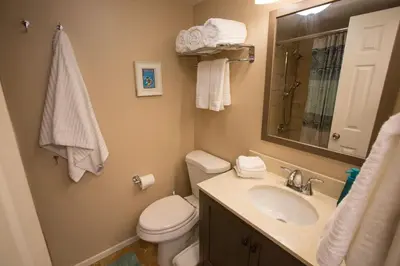 a bathroom with a toilet and a sink and a mirror at Under the Sea by Funtierland Vacation Rentals in Anaheim