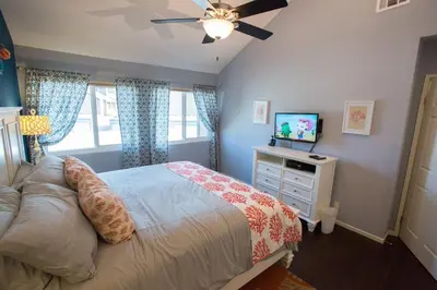 a bedroom with a bed and a flat screen tv at Under the Sea by Funtierland Vacation Rentals in Anaheim