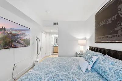 a bedroom with a bed and a large painting on the wall at Huge Stylish Apartment Santa Mon in Los Angeles