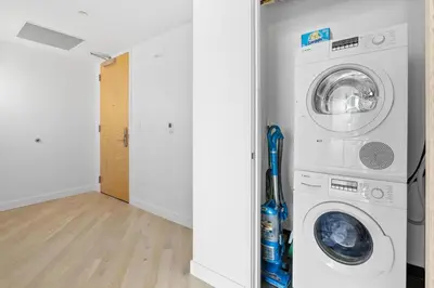 a laundry room with a washer and dryer at Rooftop Pool Modern 2BR, 2BA - Panoramic Hollywood views in Los Angeles
