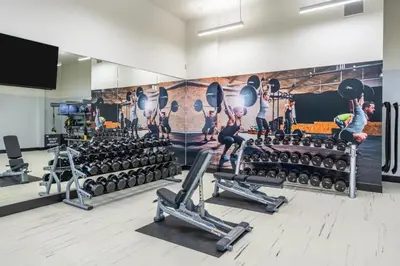 a gym with several people working out in the gym at Spacious and Bright West Hollywood Pool & Gym in Los Angeles