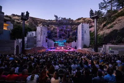 a large crowd of people sitting in front of a stage at Spacious and Bright West Hollywood Pool & Gym in Los Angeles