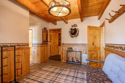 a large room with wooden walls and wooden ceiling at Ultimate Lakeview Lodge and ON THE LAKE! with a Hot-Tub! in Big Bear Lake