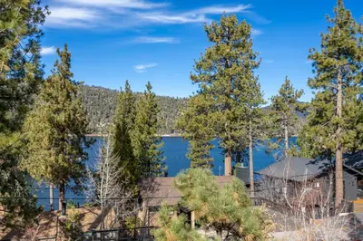 a view of a lake through the trees at Ultimate Lakeview Lodge and ON THE LAKE! with a Hot-Tub! in Big Bear Lake