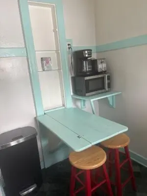 a small kitchen with a table and two stools at Charming Studio Four with Private Patio in Los Angeles