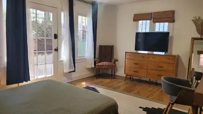 a bedroom with a bed and a tv on a dresser at Charming Studio Four with Private Patio in Los Angeles