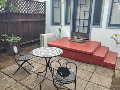 a patio with a table and chairs and a bench at Charming Studio Four with Private Patio in Los Angeles