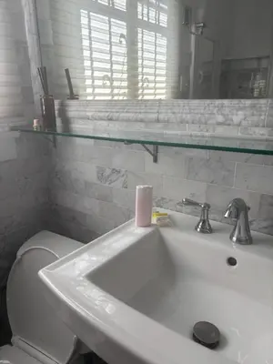 a bathroom with a sink and a toilet and a mirror at Charming Studio Four with Private Patio in Los Angeles
