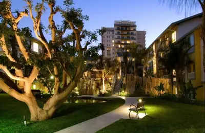 a park with a bench and a tree and a building at Oceanfront Bliss, Beach & Marina Views, Roomy 1BR in Los Angeles