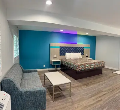 a hotel room with a bed and a couch at Royale Inn \u8001\u723a\u5ba2\u68e7 - San Gabriel, Los Angeles in Rosemead