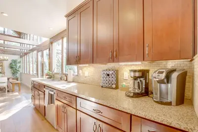 a kitchen with wooden cabinets and a coffee maker at Walk to Lake Arrowhead Village Gem with Lake Access in Lake Arrowhead