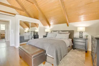 a bedroom with a large bed and a wooden ceiling at Walk to Lake Arrowhead Village Gem with Lake Access in Lake Arrowhead