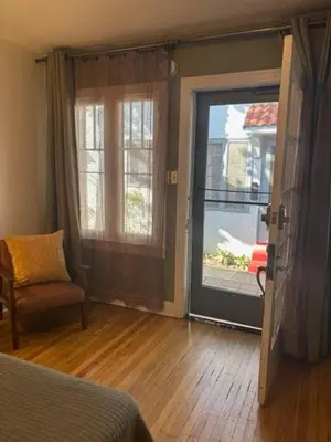 a room with a door and a chair and a window at Cozy Apartment Two in Hollywood! in Los Angeles