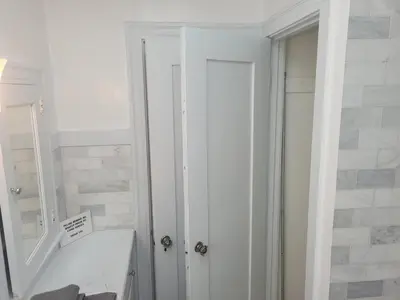 a white bathroom with a sink and a mirror at Cozy Apartment Two in Hollywood! in Los Angeles