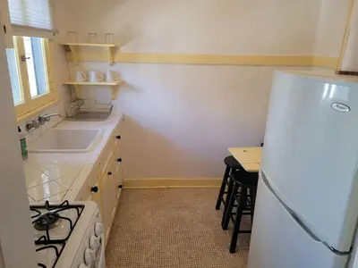 a kitchen with a white refrigerator and a sink at Cozy Apartment Two in Hollywood! in Los Angeles