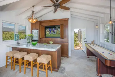 a kitchen with a bar with a pool table at Bella Vista by Paradise Retreats in Carpinteria