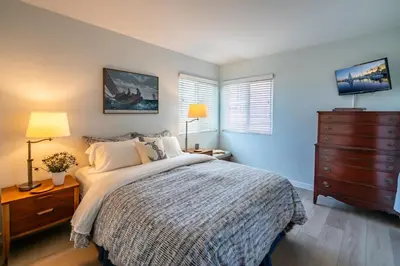 a bedroom with a bed with a dresser and a dresser at Carpinteria Dreamin by Paradise Retreats in Carpinteria