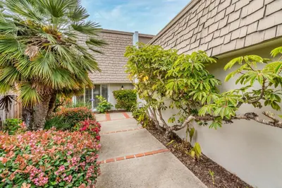 a walkway in front of a house with flowers at Keys Retreat by Paradise Retreats in Ventura