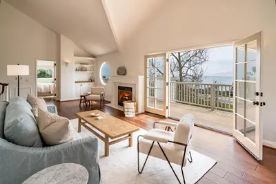 a living room with a couch and a table at Ocean Breeze Abode and Bungalow by Paradise Retreats in Summerland