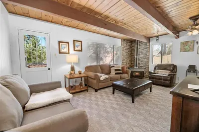 a living room with a couch and a table at Modern Lake Cabin for Family, Friends and Pets! in Big Bear Lake
